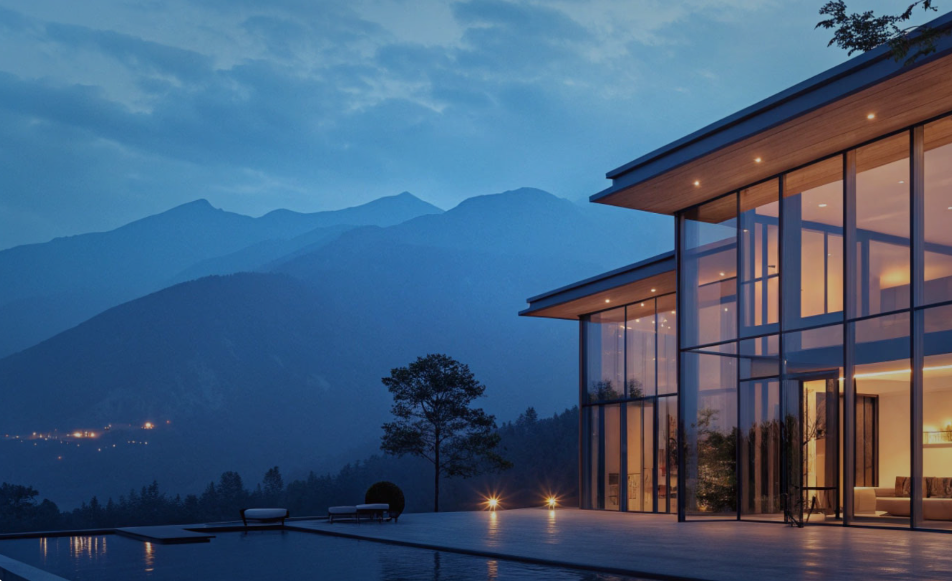 Luxury modern home with mountain backdrop at dusk